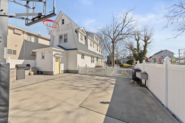 view of street featuring a gate, traffic signs, and a residential view