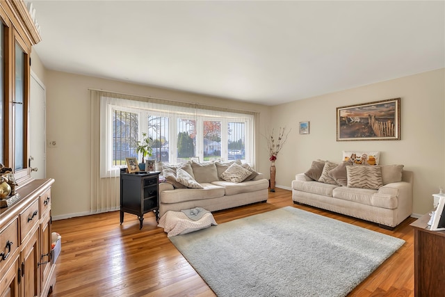 living room featuring baseboards and light wood finished floors