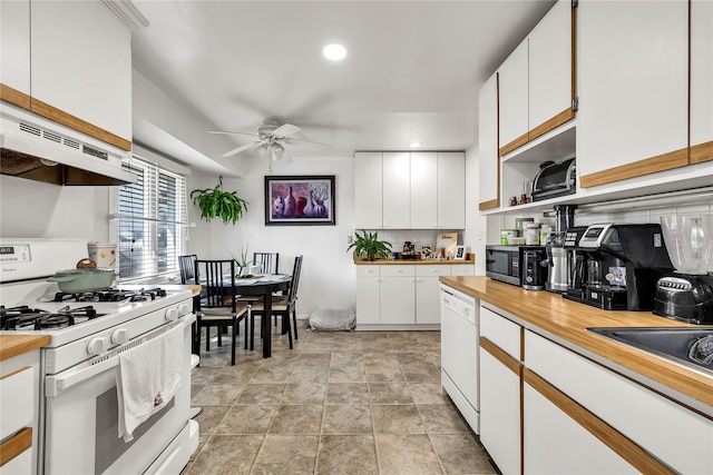 kitchen with butcher block countertops, a ceiling fan, white cabinetry, and white appliances