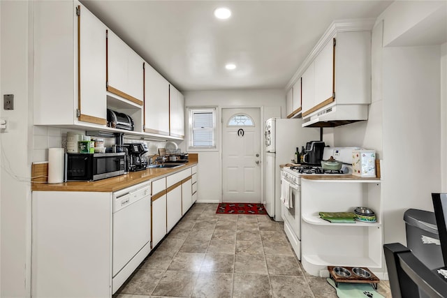 kitchen with white cabinetry, light countertops, under cabinet range hood, recessed lighting, and white appliances