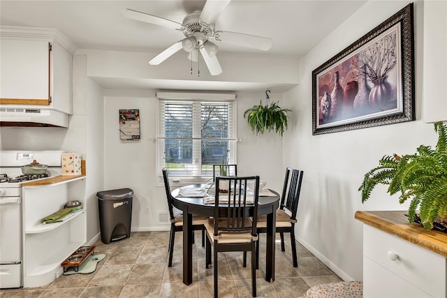 dining room featuring baseboards and a ceiling fan