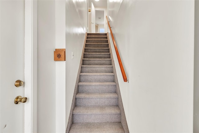 staircase featuring baseboards