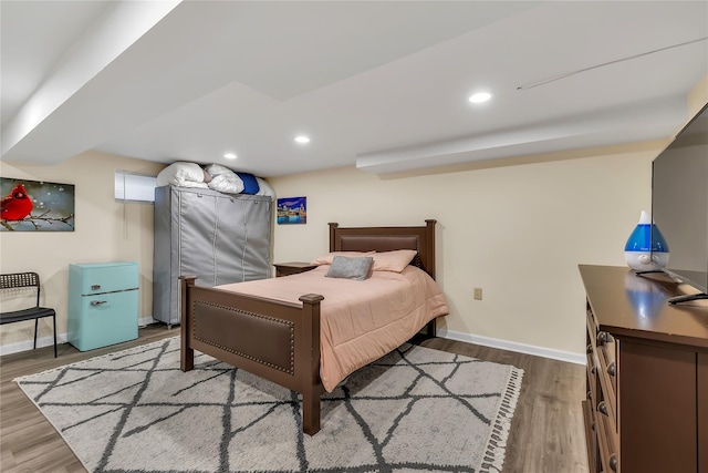 bedroom with baseboards, recessed lighting, and wood finished floors