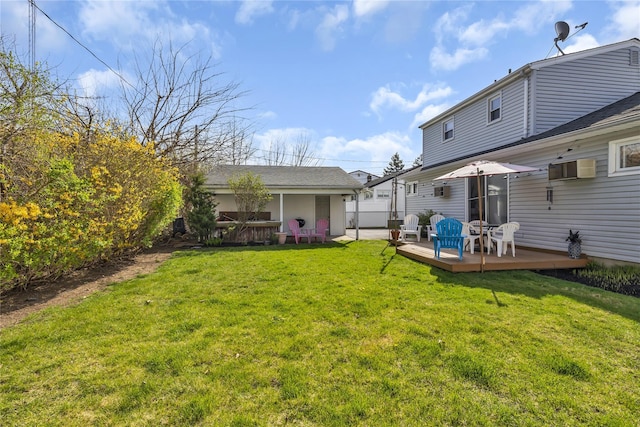rear view of house with a lawn and a wooden deck