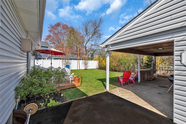 view of yard featuring a patio, a fenced backyard, and a wooden deck