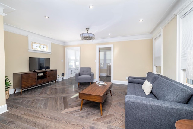 living area with crown molding, recessed lighting, baseboards, and radiator
