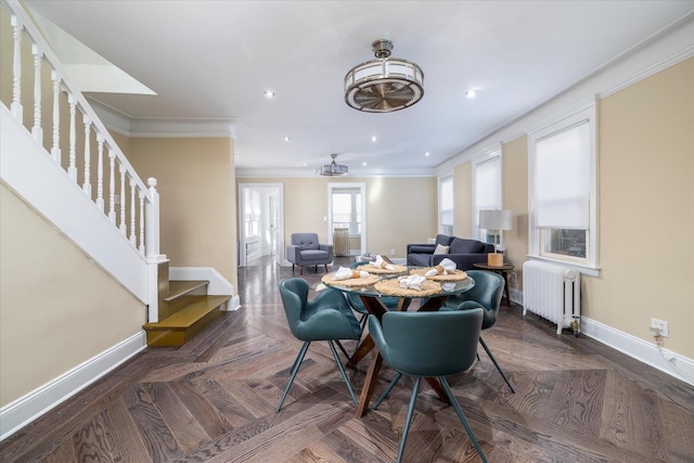 dining area featuring radiator, recessed lighting, baseboards, ornamental molding, and stairway