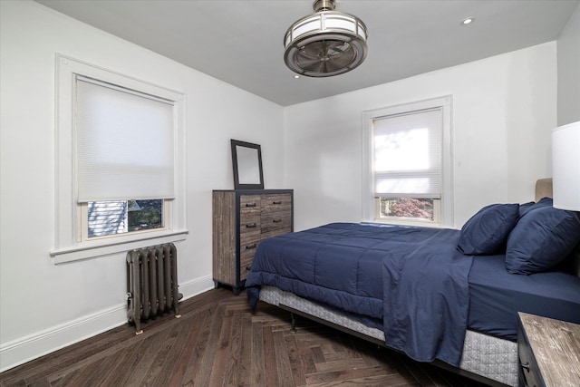 bedroom featuring baseboards and radiator