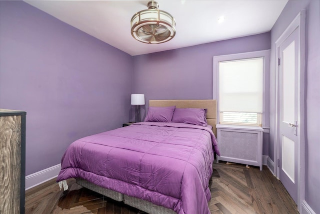 bedroom featuring radiator heating unit and baseboards