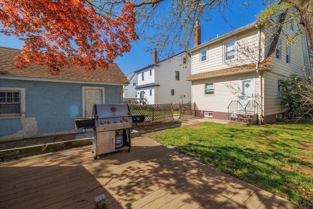 deck with a lawn, entry steps, and area for grilling