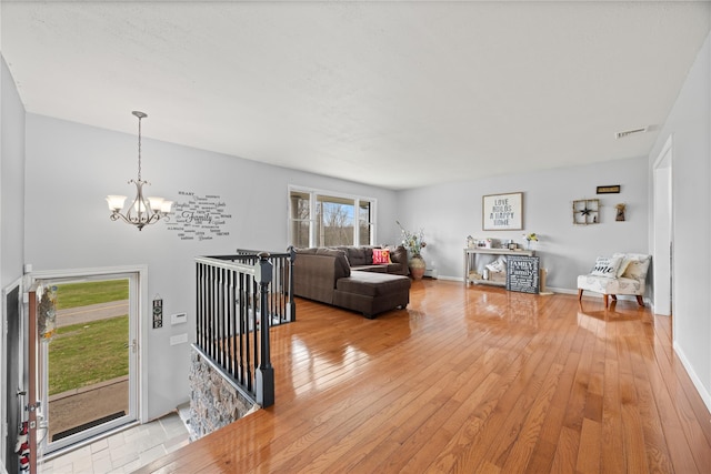 42 Horton Rd, Washingtonville, NY 10992 - living area featuring visible vents, light wood-style floors, and a chandelier