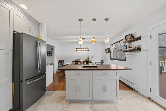 42 Horton Rd, Washingtonville, NY 10992 - kitchen with a center island, freestanding refrigerator, a baseboard radiator, wood counters, and light tile patterned floors