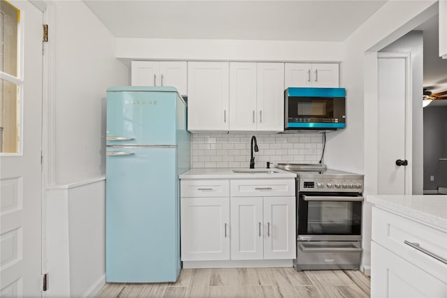 42 Horton Rd, Washingtonville, NY 10992 - kitchen featuring a sink, light countertops, electric range, white cabinetry, and freestanding refrigerator