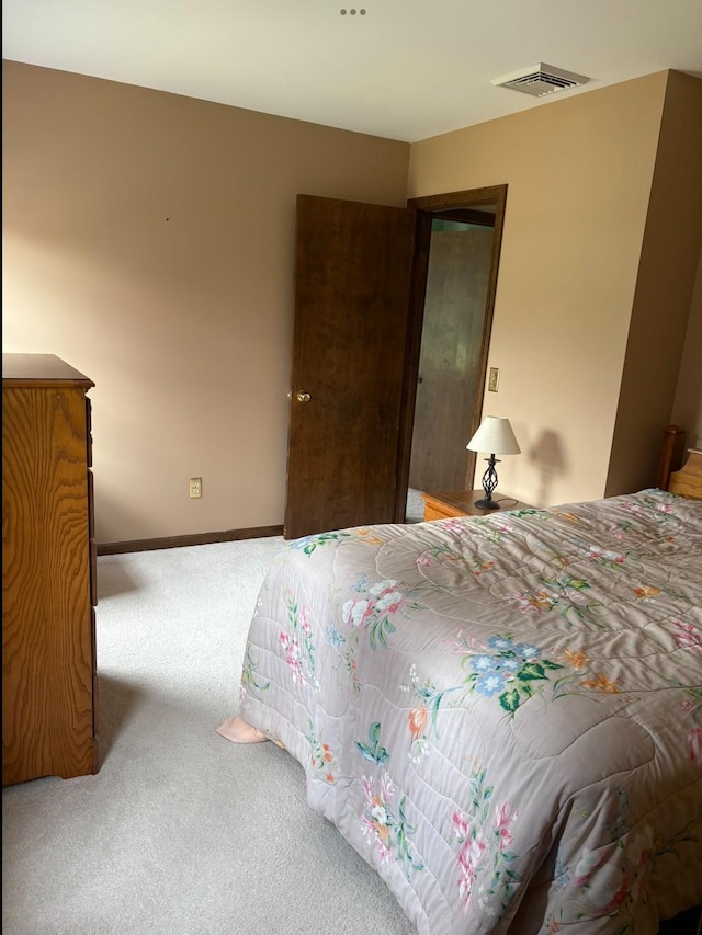 bedroom with carpet, visible vents, and baseboards