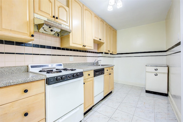 32-55 54th St, Woodside, NY 11377 - kitchen with white appliances, under cabinet range hood, light brown cabinetry, a sink, and light marble finish floors