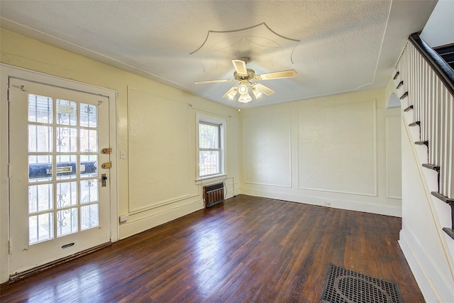 32-55 54th St, Woodside, NY 11377 - unfurnished room with a decorative wall, wood finished floors, ceiling fan, a textured ceiling, and stairs