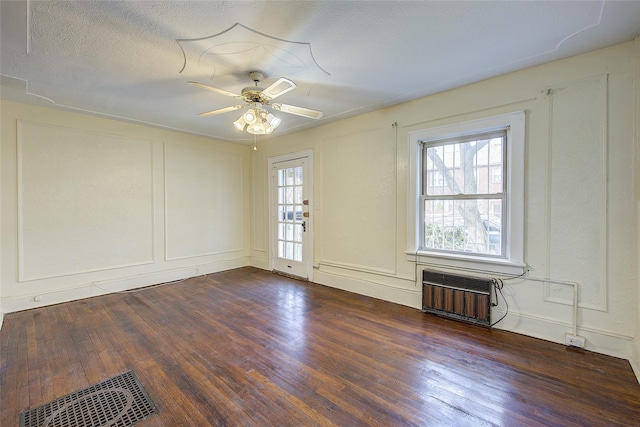 32-55 54th St, Woodside, NY 11377 - spare room featuring radiator, dark wood-type flooring, ceiling fan, and a decorative wall