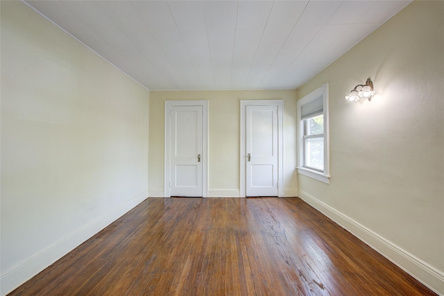 32-55 54th St, Woodside, NY 11377 - unfurnished bedroom featuring dark wood-type flooring and baseboards