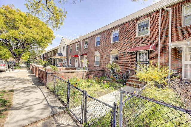 32-55 54th St, Woodside, NY 11377 - view of property featuring brick siding, a gate, and a residential view
