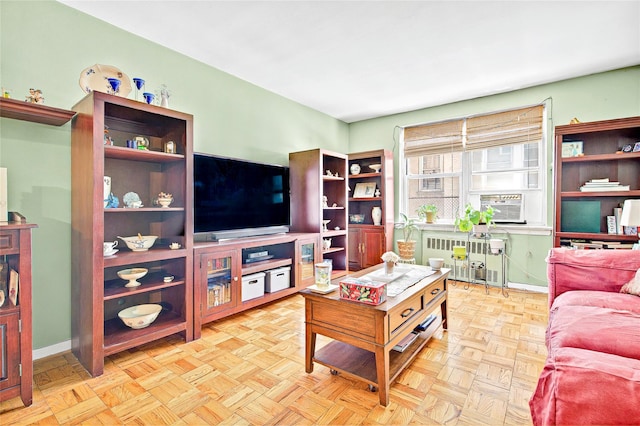 living area with radiator heating unit and baseboards