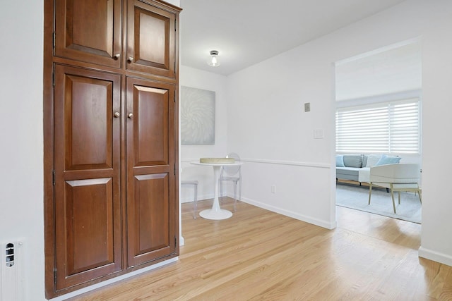 spare room featuring light wood-style floors and baseboards