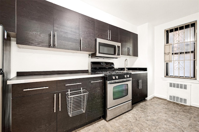 105-15 66th Rd St Unit 4E, Forest Hills, NY 11375 - kitchen with stainless steel appliances, baseboards, a sink, and radiator