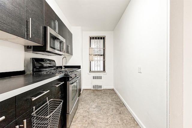 105-15 66th Rd St Unit 4E, Forest Hills, NY 11375 - kitchen with dark cabinets, a sink, appliances with stainless steel finishes, and radiator heating unit