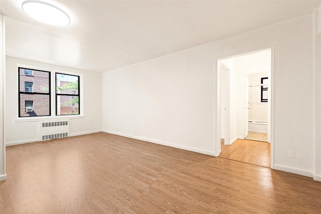 105-15 66th Rd St Unit 4E, Forest Hills, NY 11375 - spare room featuring baseboards, radiator, and light wood finished floors