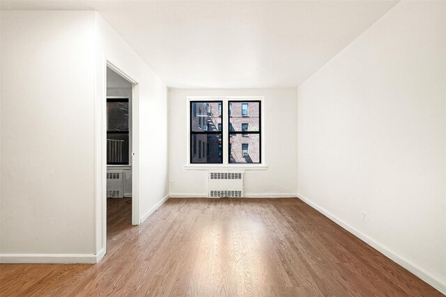 105-15 66th Rd St Unit 4E, Forest Hills, NY 11375 - empty room featuring radiator heating unit, baseboards, and wood finished floors