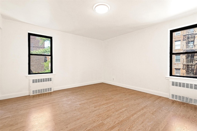 105-15 66th Rd St Unit 4E, Forest Hills, NY 11375 - spare room with baseboards, radiator, and light wood-type flooring