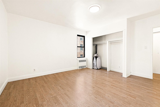 105-15 66th Rd St Unit 4E, Forest Hills, NY 11375 - unfurnished bedroom featuring radiator, baseboards, a closet, and light wood-type flooring