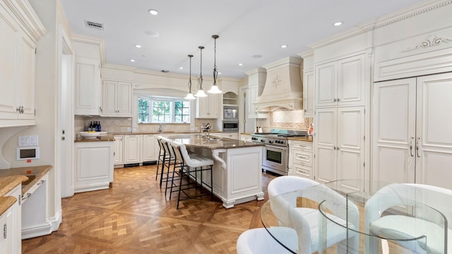 3 Pin Oak Ct, Old Brookville, NY 11545 - kitchen featuring appliances with stainless steel finishes, custom range hood, a kitchen bar, white cabinets, and recessed lighting