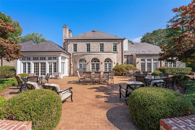 3 Pin Oak Ct, Old Brookville, NY 11545 - back of house featuring french doors, a high end roof, outdoor dining area, and a chimney