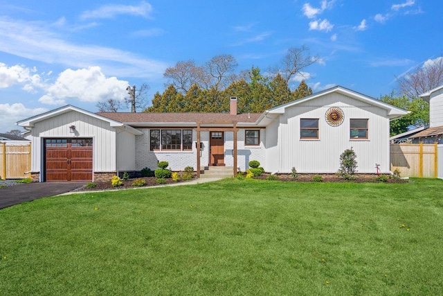 single story home featuring a garage, fence, a front lawn, and driveway