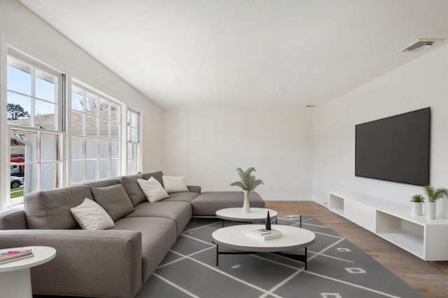 living room featuring wood finished floors and visible vents