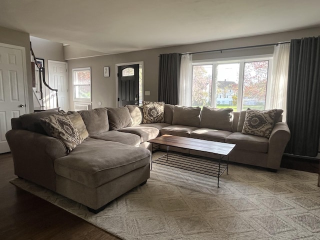 living room with light wood-style floors and stairway