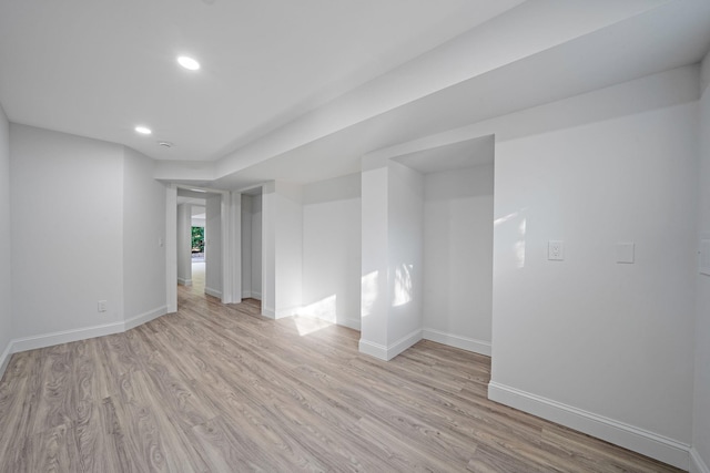 spare room featuring recessed lighting, light wood-type flooring, and baseboards