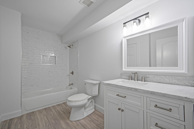 bathroom featuring toilet, shower / bathtub combination, visible vents, wood finished floors, and vanity