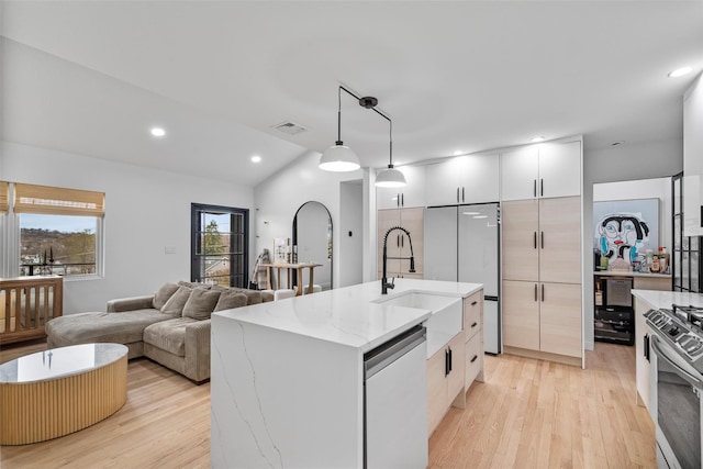 18 Mcbride Pl, Goshen, NY 10924 - kitchen featuring appliances with stainless steel finishes, light wood-style floors, hanging light fixtures, modern cabinets, and light stone countertops
