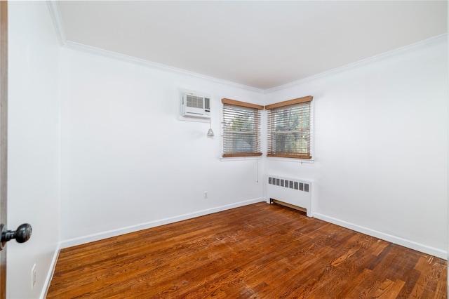 empty room featuring crown molding, a wall unit AC, baseboards, radiator, and dark wood-style flooring
