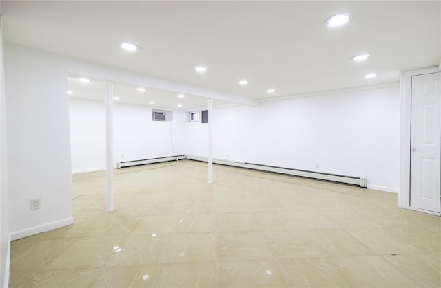 finished below grade area featuring baseboards, recessed lighting, a wall unit AC, and a baseboard heating unit