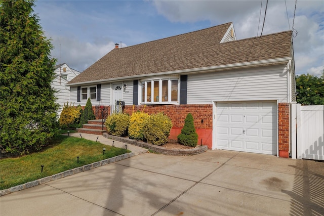 view of front of home with a chimney, concrete driveway, a shingled roof, and brick siding