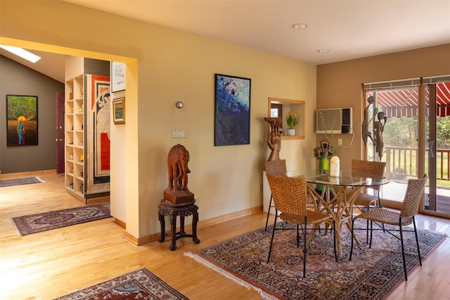 dining room featuring recessed lighting, a wall mounted AC, wood finished floors, and baseboards