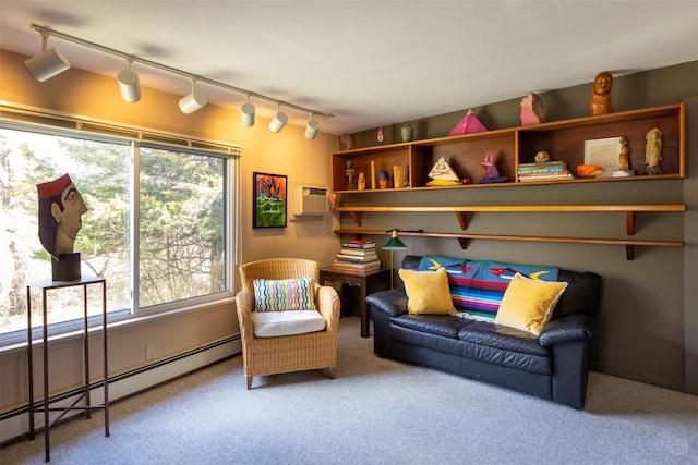 living area featuring a baseboard heating unit, track lighting, carpet flooring, and a wall mounted air conditioner
