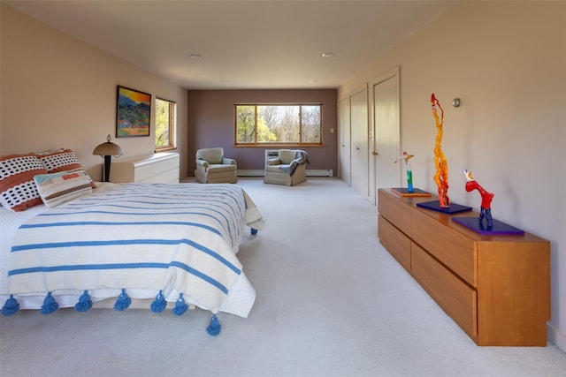 bedroom with light carpet and baseboard heating