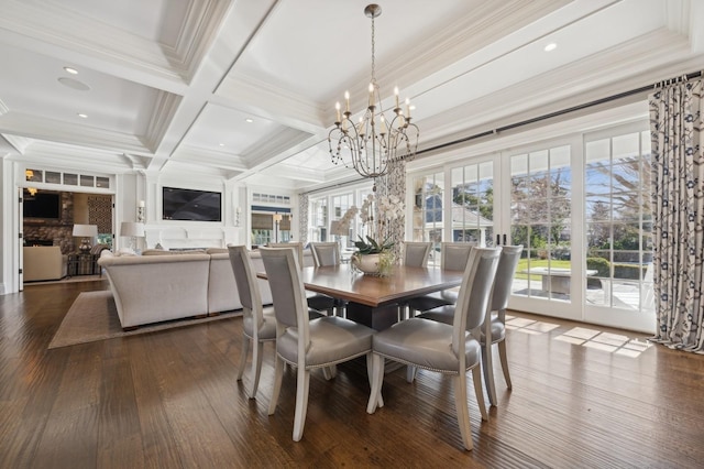 dining space featuring dark wood finished floors, coffered ceiling, an inviting chandelier, ornamental molding, and beam ceiling