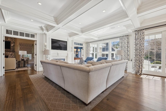 living area featuring beam ceiling, dark wood-style flooring, coffered ceiling, crown molding, and a fireplace