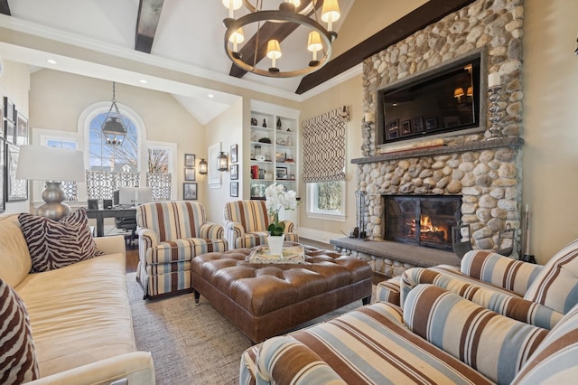 living area with an inviting chandelier, a healthy amount of sunlight, built in features, and a stone fireplace