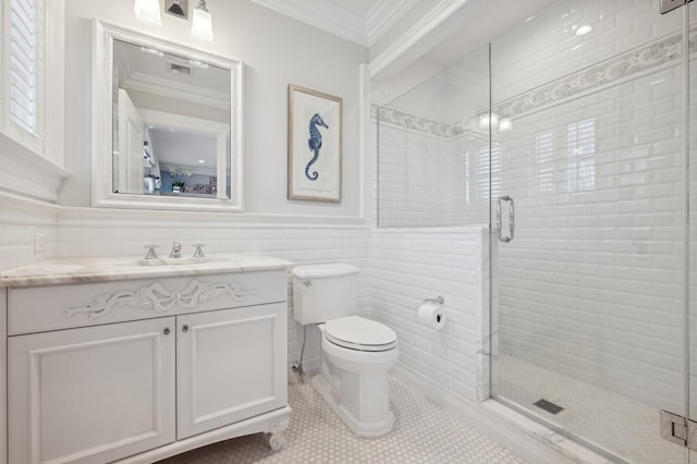 full bathroom featuring tile walls, toilet, a shower stall, and crown molding