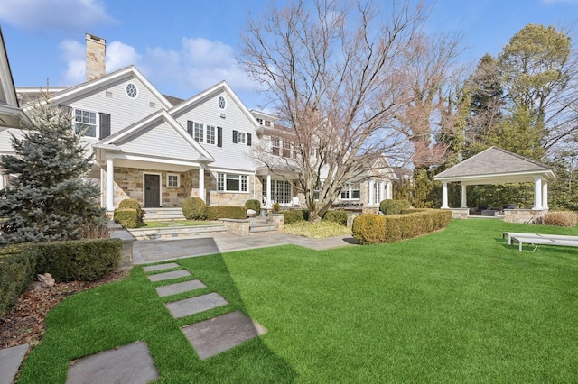 view of yard with a porch and a gazebo